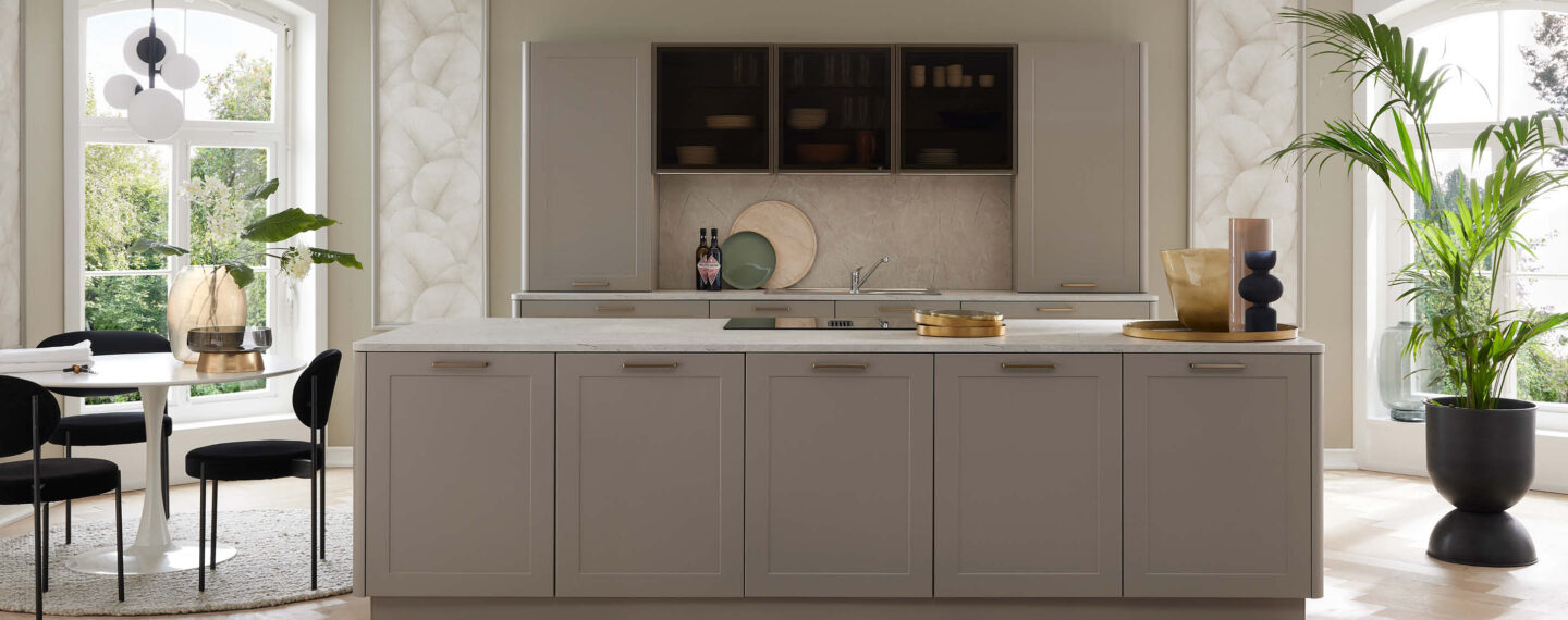 Stilvolle Wohnküche mit großer Kochinsel, hellen Fronten und eleganten Akzenten – modernes Küchendesign für offenes Wohnen.