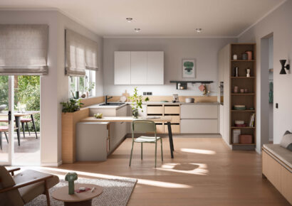 Moderne Häcker Küche in hellen Tönen mit Holzdetails, integrierter Sitzlösung und offenen Regalen im freundlichen, lichtdurchfluteten Wohnraum